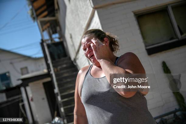 Single mother of two is overcome with emotion after being served a court eviction order for non-payment of rent on September 30, 2020 in Phoenix,...