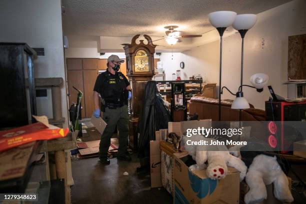 Maricopa County constable Lenny McCloskey inspects an apartment while serving an eviction order on September 30, 2020 in Glendale, Arizona. Thousands...