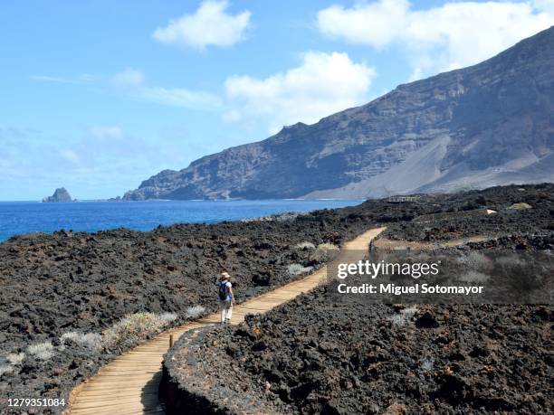 woman walking on a volcanic path - hierro stock pictures, royalty-free photos & images