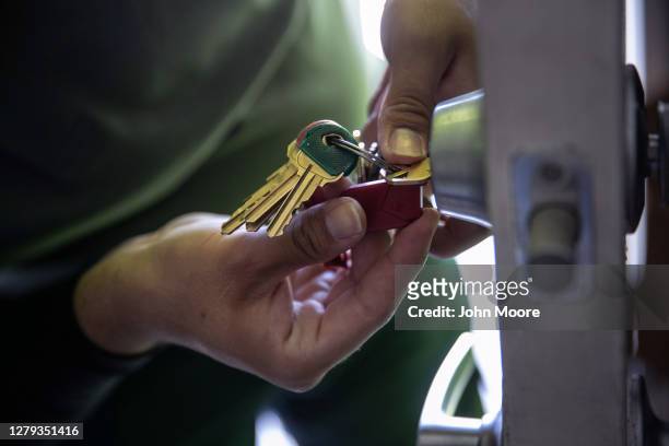 An apartment maintenance man changes the lock of an apartment after constables posted an eviction order on October 7, 2020 in Phoenix, Arizona....