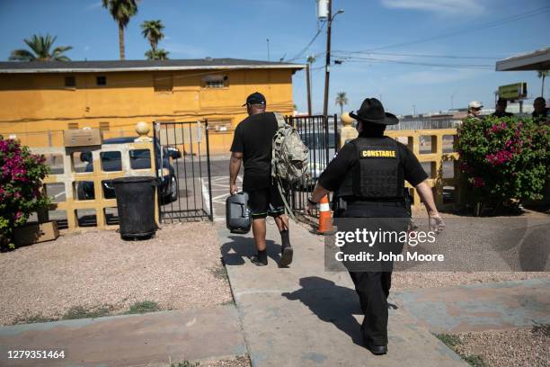 Maricopa County constable Darlene Martinez evicts a tenant on October 7, 2020 in Phoenix, Arizona. Thousands of court-ordered evictions continue...