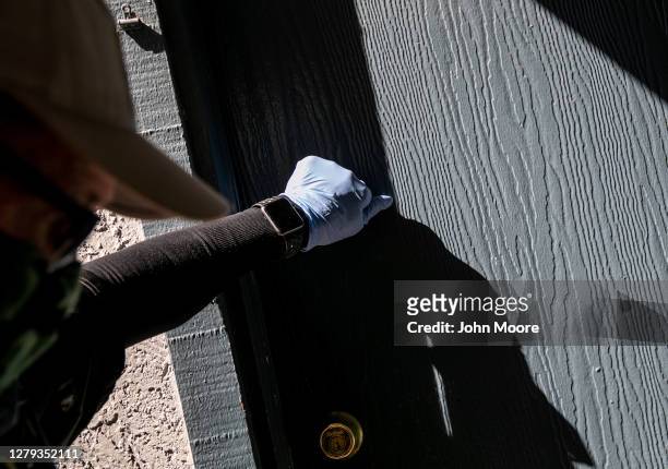 Maricopa County constable Lenny McCloskey knocks on an apartment door before evicting tenants for non-payment of rent on October 6, 2020 in Phoenix,...