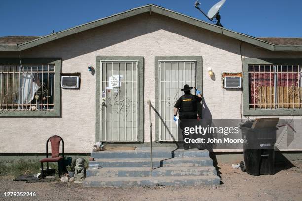 Maricopa County constable Darlene Martinez knocks on a door before posting an eviction order on October 1, 2020 in Phoenix, Arizona. Thousands of...