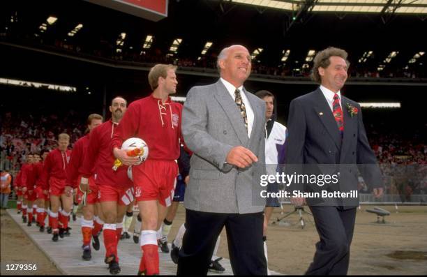 Ronnie Moran of Liverpool and Malcom Crosby of Sunderland lead their teams out before the FA Cup final at Wembley Stadium in London. Liverpool won...