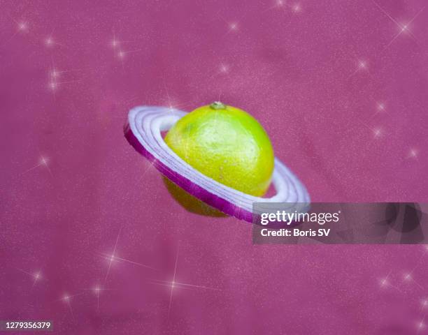 lime with onion rings as saturn, sparkling background - glitter fruit stock pictures, royalty-free photos & images