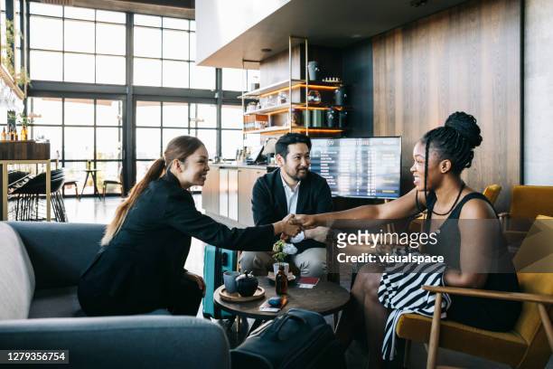 group of entrepreneurs at the airport - airport business lounge stock pictures, royalty-free photos & images