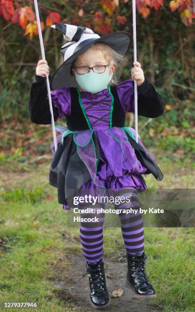 halloween witch on a swing in a covid mask - 2020 glasses stock pictures, royalty-free photos & images