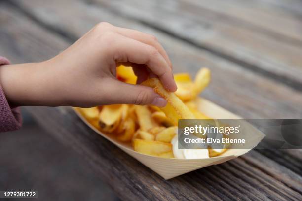 close up of child dipping takeaway chips into a portion of mayonnaise - mayonnaise stock-fotos und bilder