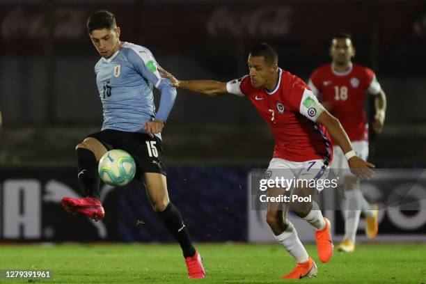 Federico Valverde of Uruguay fights for the ball with Alexis Sanchez of Chile during a match between Uruguay and Chile as part of South American...