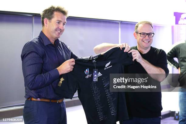 Rugby Chief Executive Mark Robinson presents Nura Chief Operating Officer Morgan Donoghue with an All Blacks jersey during a New Zealand Rugby and...