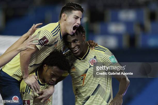 Duván Zapata of Colombia celebrates after scoring the first goal of his team with teammate Juan Cuadrado and James Rodríguez during a match between...