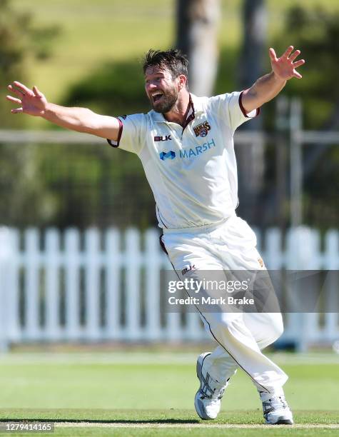 Michael Neser of the Queensland Bulls celebrates the wicket of Jordan Silk of the Tasmanian Tigers during day one of the Sheffield Shield match...