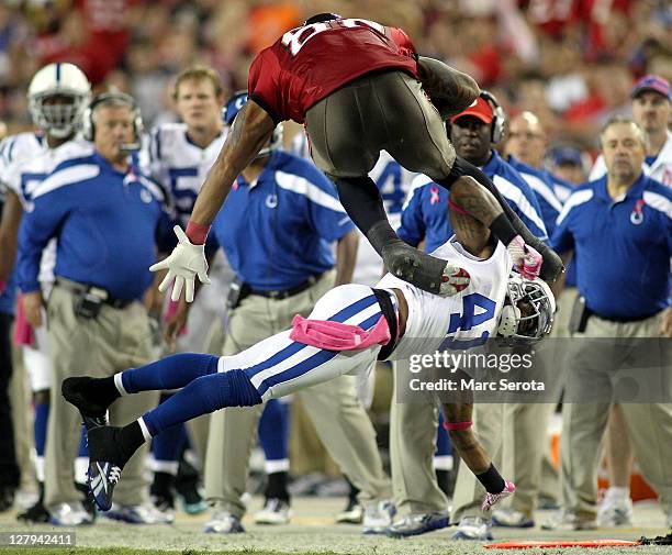 Tight end Kellen Winslow of the Tampa Bay Buccaneers is brought down by Safety Antoine Bethea of the Indianapolis Colts at Raymond James Stadium on...