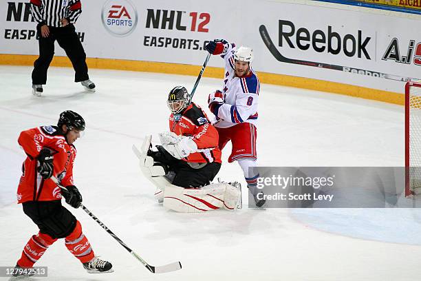 Brandon Prust of the New York Rangers gets tangled up with Jussi Markkanen of EV Zug at the Bossard Arena during the 2011 NHL Compuware Premiere...
