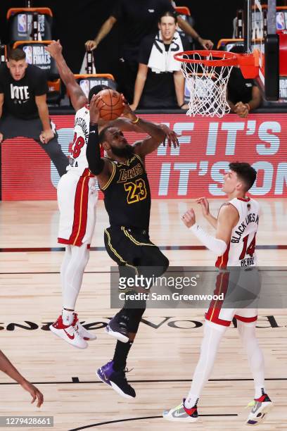 LeBron James of the Los Angeles Lakers drives to the basket over Tyler Herro of the Miami Heat during the fourth quarter in Game Five of the 2020 NBA...