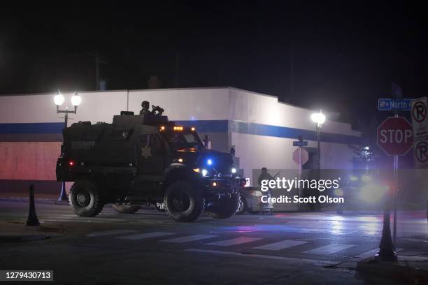 Police and National Guard clear the streets following a brief skirmish with demonstrators near the Wauwatosa City Hal on October 09, 2020 in...