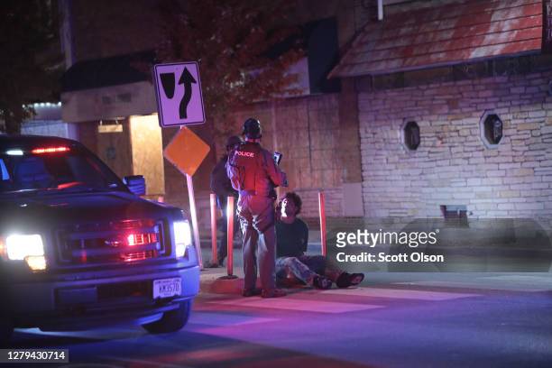 Police take people into custody who were out after curfew follow a brief skirmish with demonstrators near the Wauwatosa City Hal on October 09, 2020...