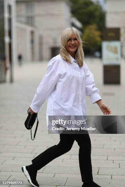 Judith Mosqueira do Amaral wearing a Seidensticker shirt, Chanel bag, black jeans and Balenciaga sneaker on October 07, 2020 in Cologne, Germany.