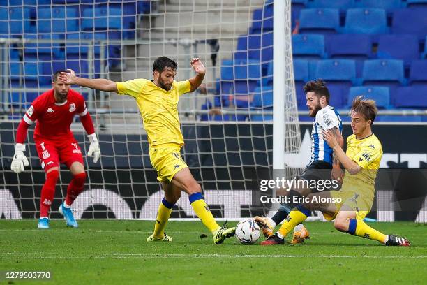 Miguel Juan Llambrich of RCD Espanyol competes for the ball with Javi Castro and David Fernandez of AD Alcorcon during the La Liga Smartbank match...