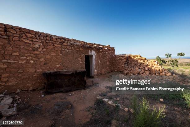 scenic view of ruin of a traditional north african mud house against sky at sunset - stone house stock pictures, royalty-free photos & images