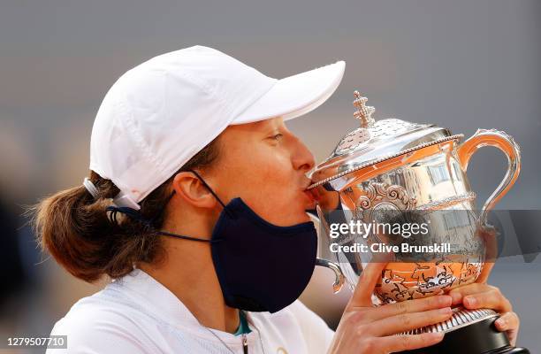 Iga Swiatek of Poland kisses the Suzanne-Lenglen cup following victory in her Women's Singles Final against Sofia Kenin of The United States of...