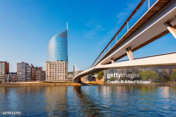 modern bridge crossing meuse river in liège belgium - liege imagens e fotografias de stock