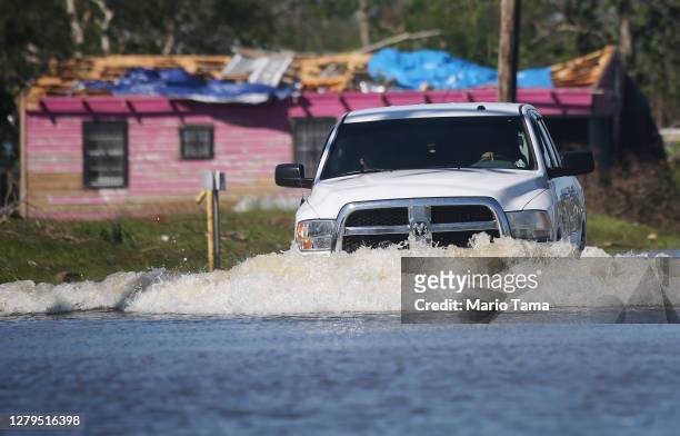 Truck drives through flood waters from Hurricane Delta in a neighborhood still recovering from Hurricane Laura on October 10, 2020 in Lake Charles,...