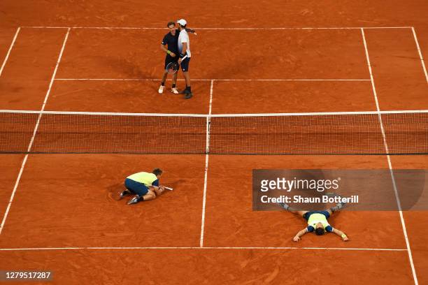 Kevin Krawietz and Andreas Mies of Germany celebrate after winning championship point in their Men's Doubles Final on Court Philippe-Chatrier against...