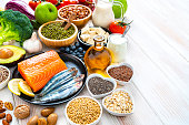 Foods to lower cholesterol and heart care shot on wooden table. Copy space