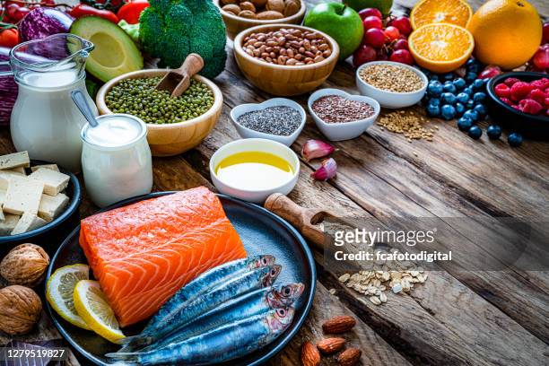 foods to lower cholesterol and heart care shot on wooden table. copy space - ldl cholesterol stock pictures, royalty-free photos & images