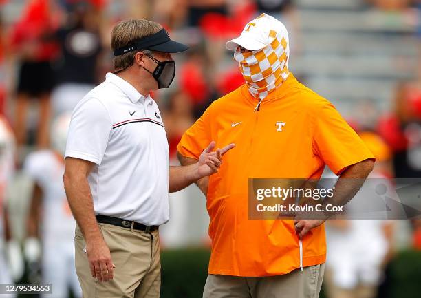 Head coach Kirby Smart of the Georgia Bulldogs and head coach Jeremy Pruitt of the Tennessee Volunteers converse during pregame warmups at Sanford...