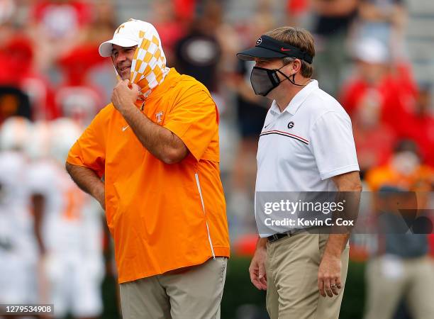 Head coach Kirby Smart of the Georgia Bulldogs and head coach Jeremy Pruitt of the Tennessee Volunteers converse during pregame warmups at Sanford...