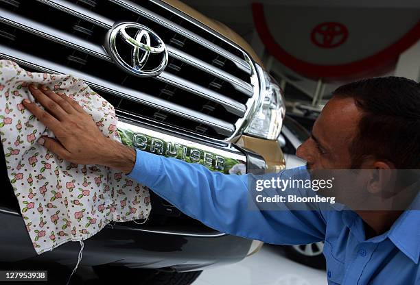 An employee polishes a Toyota Motor Corp. Land Cruiser sport-utility vehicle at the Toyota Central Motors dealership in Karachi, Pakistan, on Monday,...