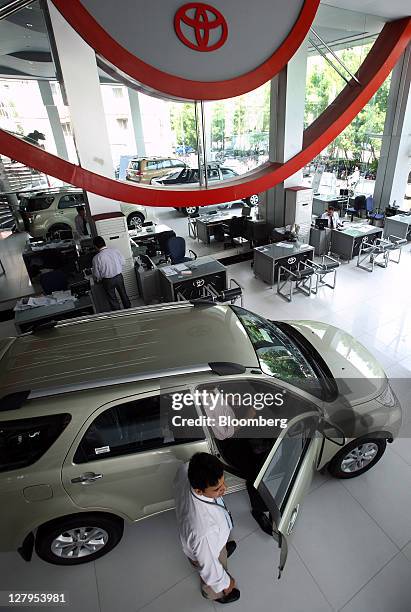 Visitor inspects a Toyota Motor Corp. Sport-utility vehicle at the Toyota Central Motors dealership in Karachi, Pakistan, on Monday, Oct. 3, 2011....