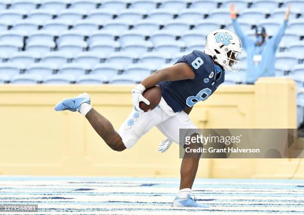 Michael Carter of the North Carolina Tar Heels scores a touchdown against the Virginia Tech Hokies during their game at Kenan Stadium on October 10,...