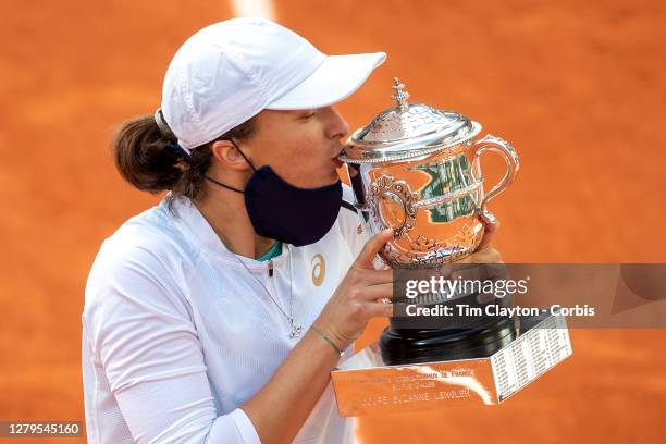 October 10. Iga Swiatek of Poland kisses the trophy after defeating Sofia Kenin of the United States in the Singles Final on Court Philippe-Chatrier...