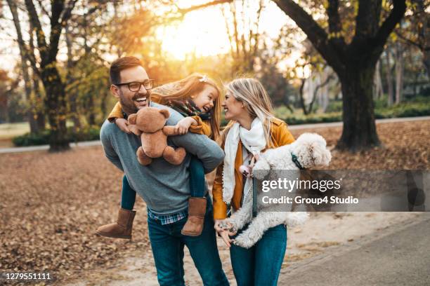 happy family - autumn dog stock pictures, royalty-free photos & images