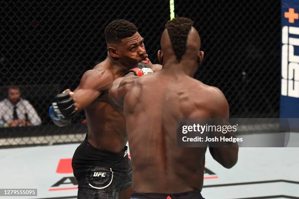 Impa Kasanganay punches Joaquin Buckley in their middleweight bout during the UFC Fight Night event inside Flash Forum on UFC Fight Island on October...