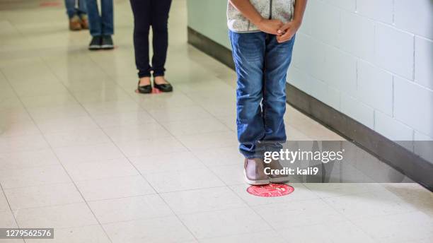 elementary school students in hallway social distancing - two meters stock pictures, royalty-free photos & images