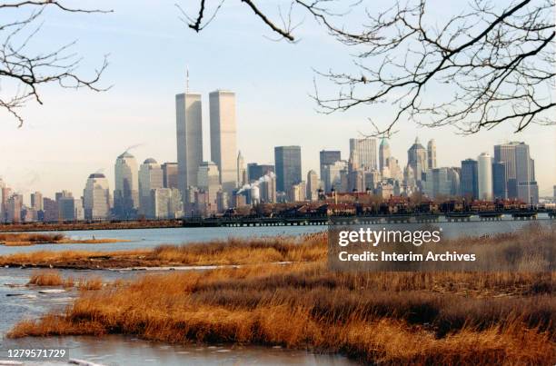 View looking east across the Hudson River from Liberty State Park towards Ellis Island and the World Trade Center and the surrounding skyline, Jersey...