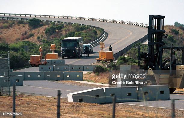 Military Police and K9 officers check identification and search vehicles entering Camp Pendleton military base, September 12, 2001 in Oceanside,...