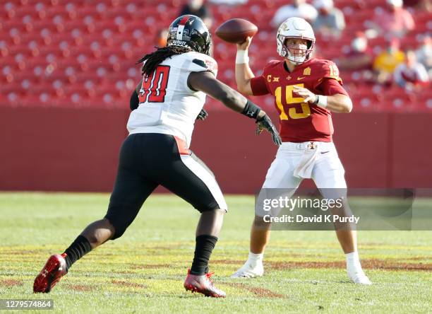 Quarterback Brock Purdy of the Iowa State Cyclones throws the ball as defensive lineman Devin Drew of the Texas Tech Red Raiders defends in the...