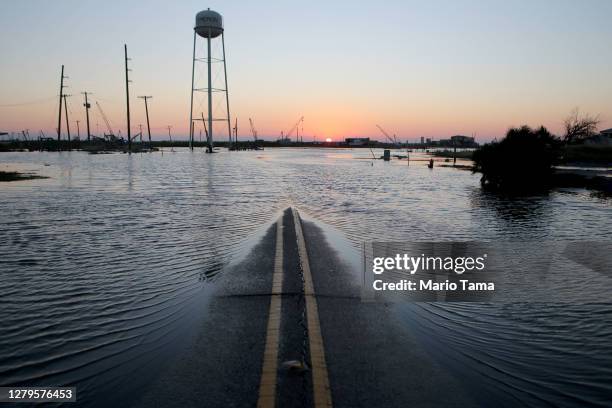 Flood waters cover a roadway near structures damaged by Hurricane Laura on October 10, 2020 in Cameron, Louisiana. Hurricane Delta made landfall as a...