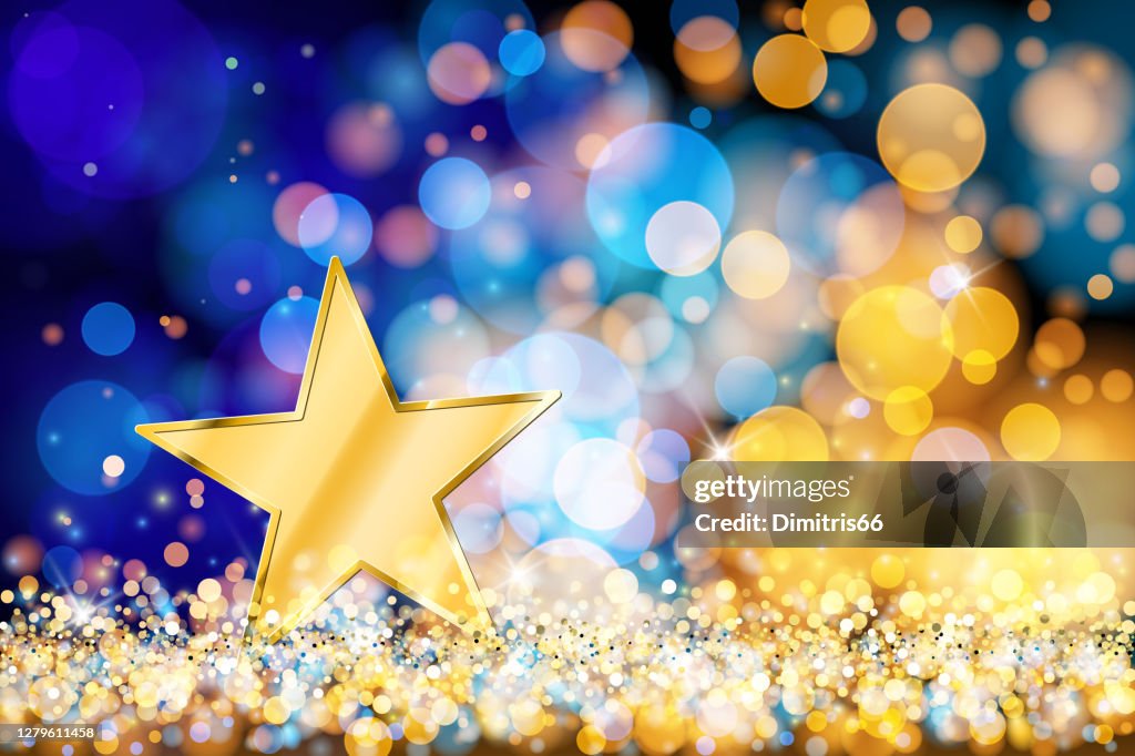 Gold star on defocused lights. Blue and gold bokeh decoration
