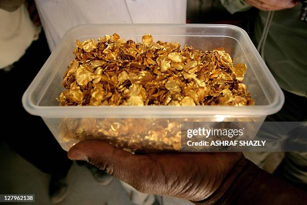 Tub full of gold nuggets is shown at the Ariab company gold mine in the Sudanese desert, 800 kms northeast of the capital Khartoum, on October 3,...