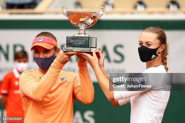 Timea Babos of Hungary and Kristina Mladenovic of France lift the winners trophy following victory in their Women's Doubles Final against Desirae...