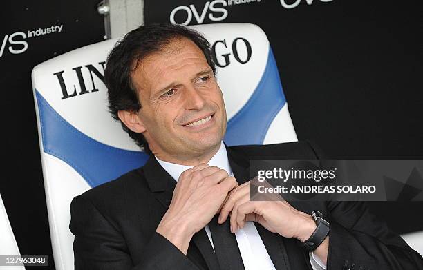 Milan's Brasilian coach Massimiliano Allegri smiles as he takes place for his team's Italian Serie A football match against Brescia on April 23, 2011...