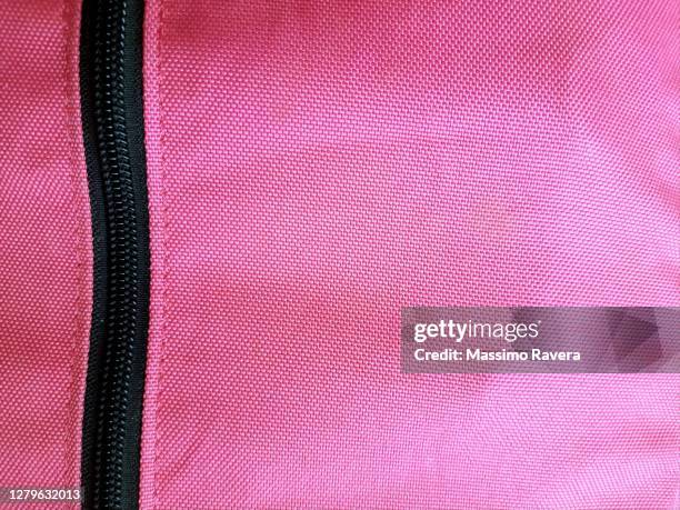 pink fabric with black zip - polyester stock-fotos und bilder