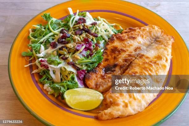 cooked tilapia fillet with salad - tilapia stock pictures, royalty-free photos & images