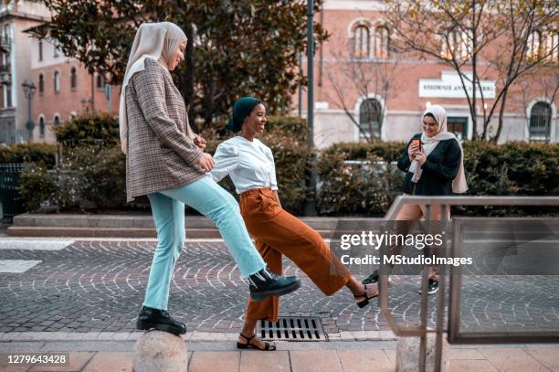 young women dancing on the street - islamic action front stock pictures, royalty-free photos & images